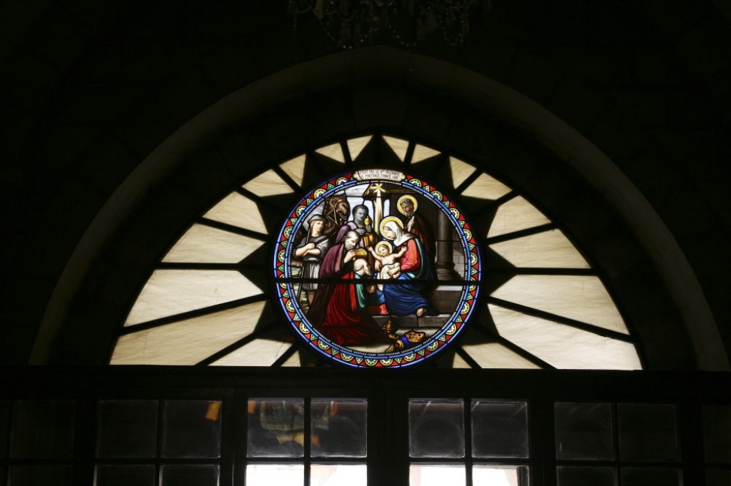 Stained glass window in St. Catherine's Church showing the Virgin Mary holding the baby Jesus.